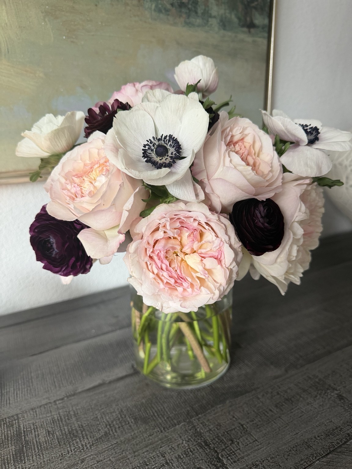 Romantic bridal bouquet with blush garden roses, white anemones and deep burgundy flowers by Petite Petal
