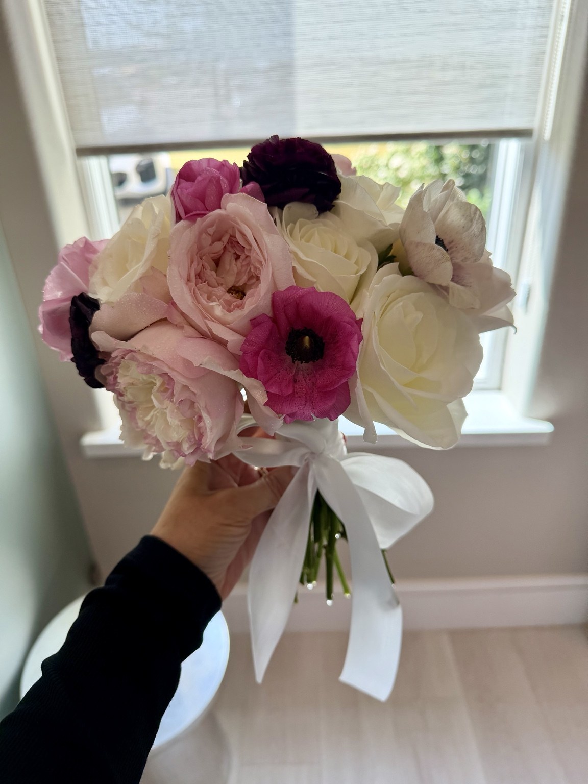 Soft pink and white bridal bouquet with roses, ranunculus and anemones by Petite Petal