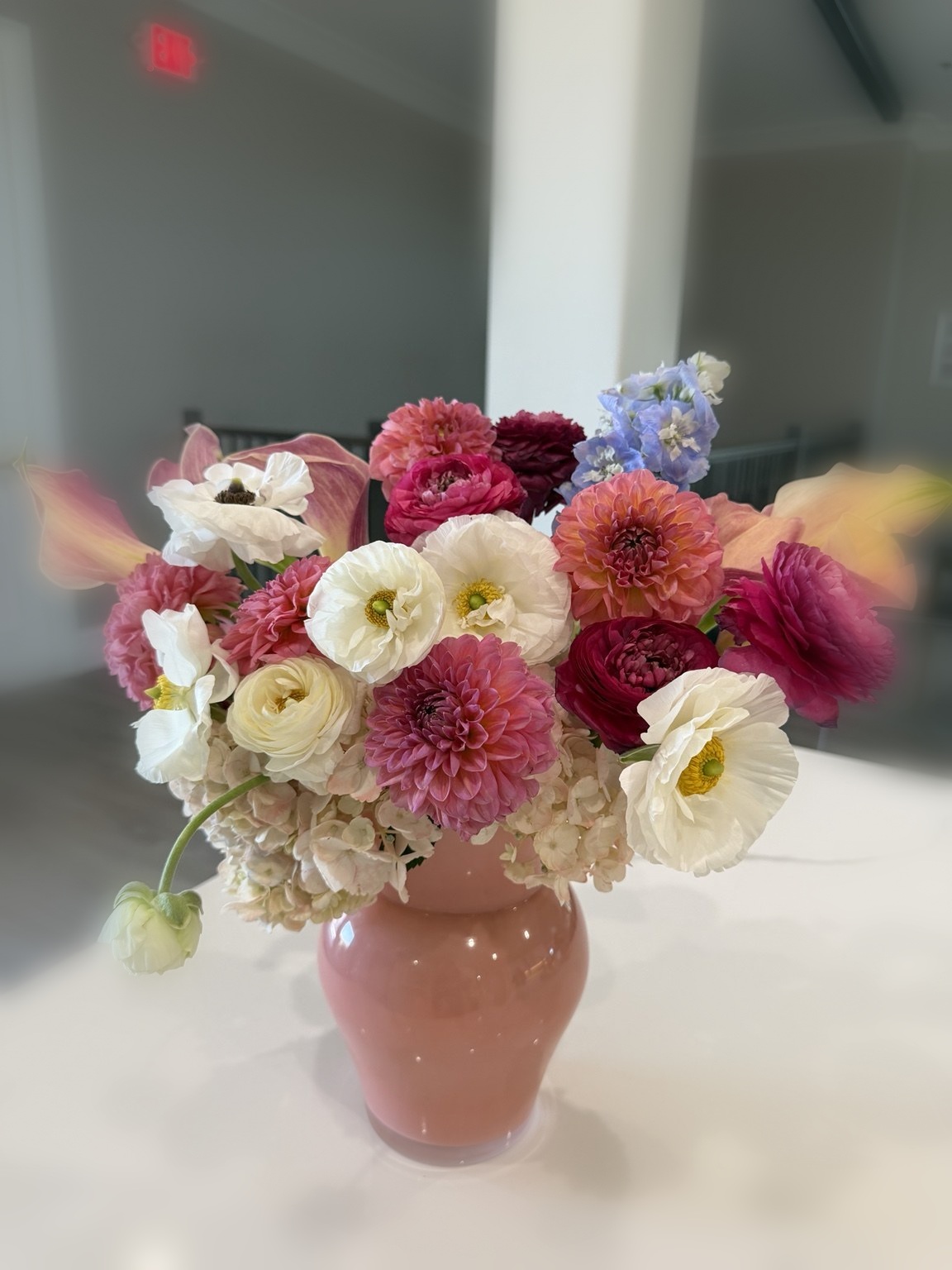 Colorful pink vase arrangement with dahlias, poppies, roses and hydrangea by Petite Petal