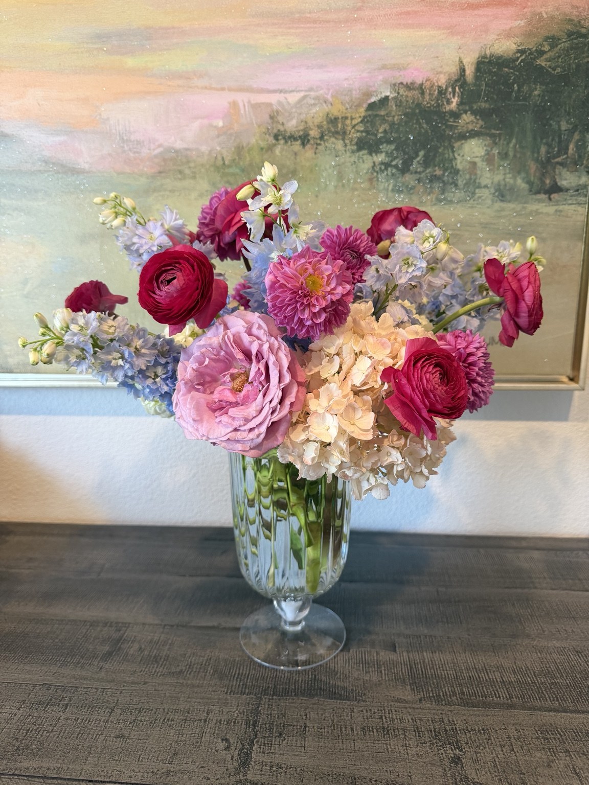 Pink and colorful custom floral arrangement in a glass vase by Petite Petal