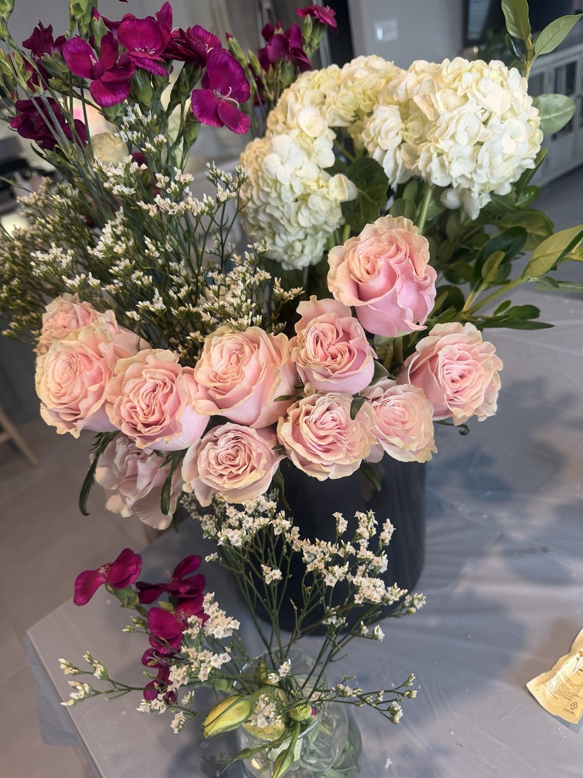 Large pink rose and hydrangea event floral arrangement with airy greenery by Petite Petal